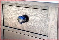 Close-up of smaller upper drawer and turned oak pull.